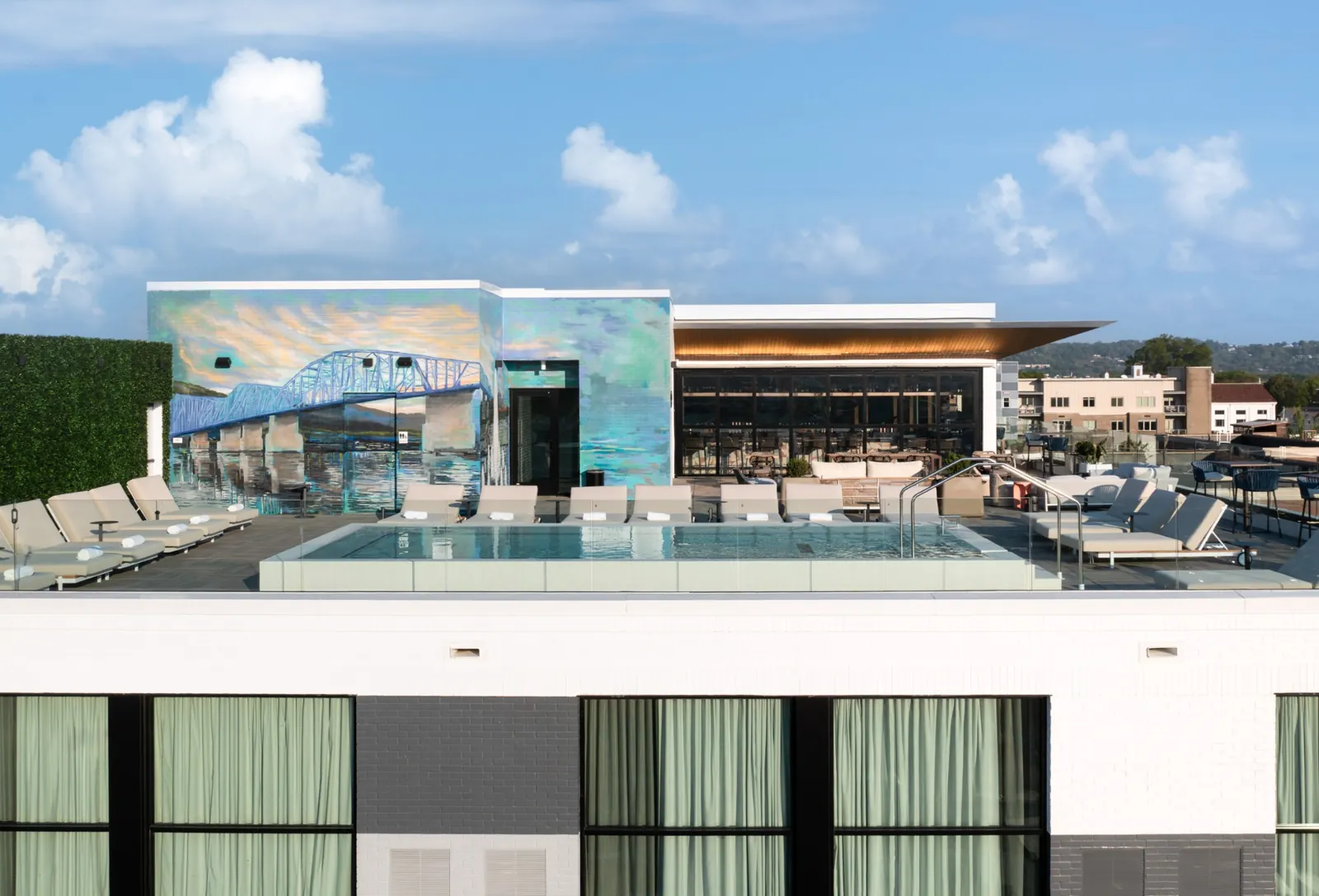 Caption by Hyatt rooftop pool with a mural of Chattanooga's bridge